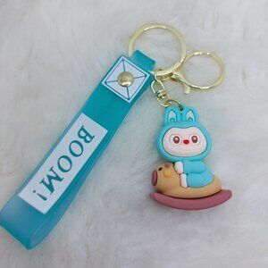 2/$25 Labubu rocking horse blue keychain with strap that reads "Boom!"